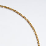 Rooted Rope Chain Necklace – close-up of the braided rope texture, gold, on a pale grey background