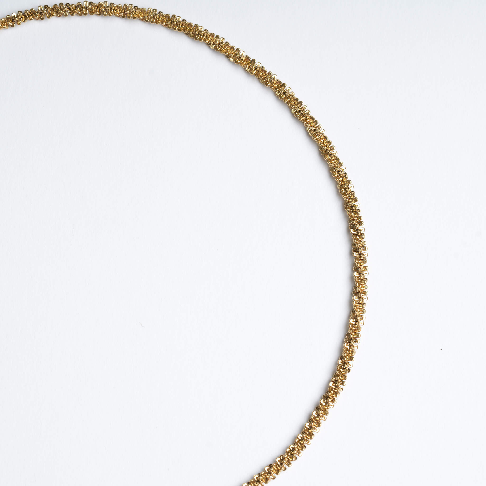 Rooted Rope Chain Necklace – close-up of the wider rope chain, gold, on a pale grey background