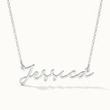 Signature Name Necklace – name "Jessica" in script hanging on a fine chain, closer view, silver, on ivory background