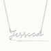 Signature Name Necklace – name "Jessica" in script hanging on a fine chain, closer view, silver, on ivory background