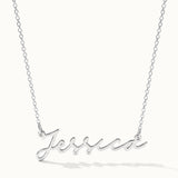 Signature Name Necklace – name "Jessica" in script hanging on a fine chain, silver, on ivory background