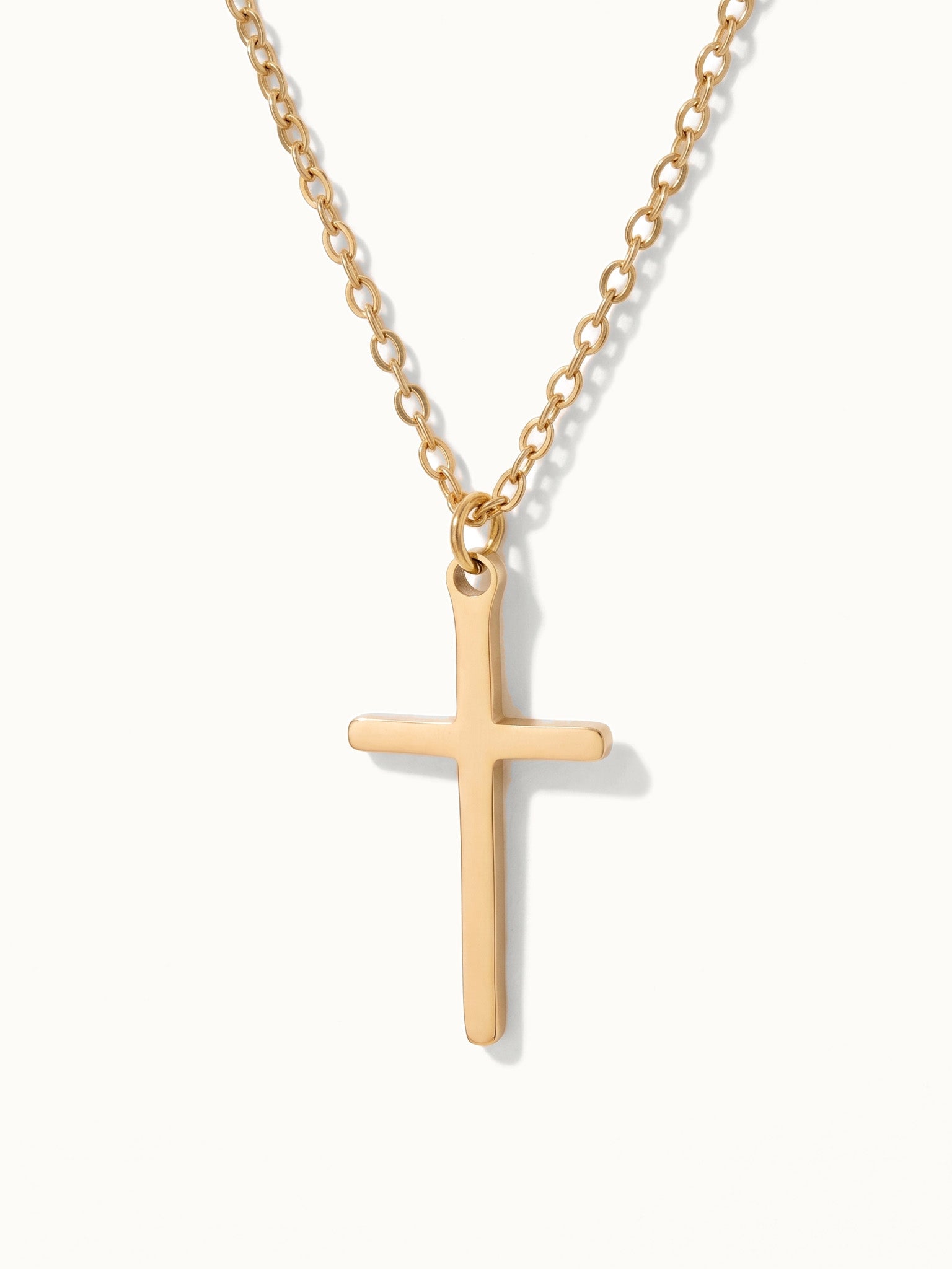 Steadfast Cross Necklace in gold, close-up of the cross