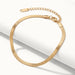 Still Waters Herringbone Bracelet – draped over a white step, gold, on ivory background