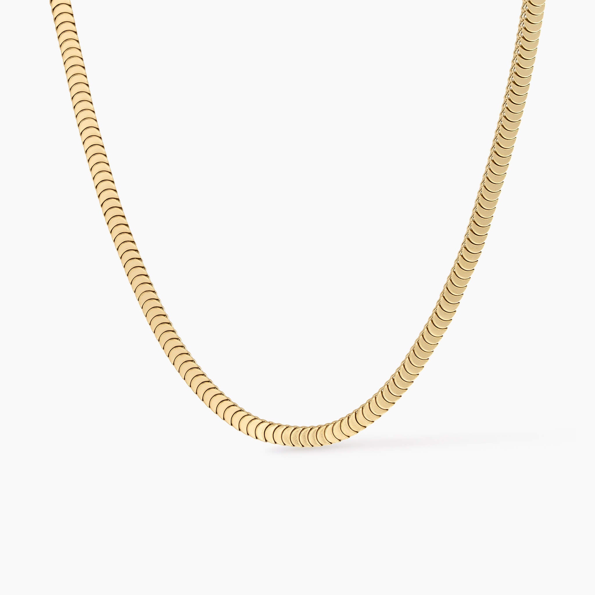 Still Waters Herringbone Necklace in gold, flat lay on a white background