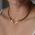 Still Waters Herringbone Necklace – worn close at the collarbone, gold, white strap top