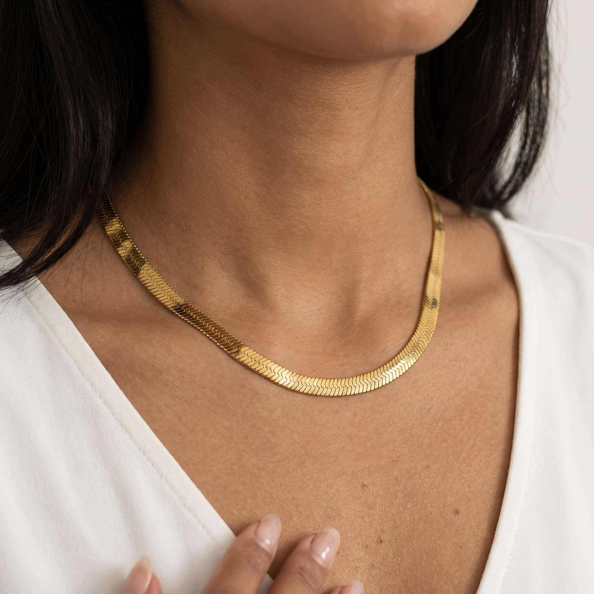 Sunday Best Herringbone Necklace – worn at the collarbone, gold, white V-neck top
