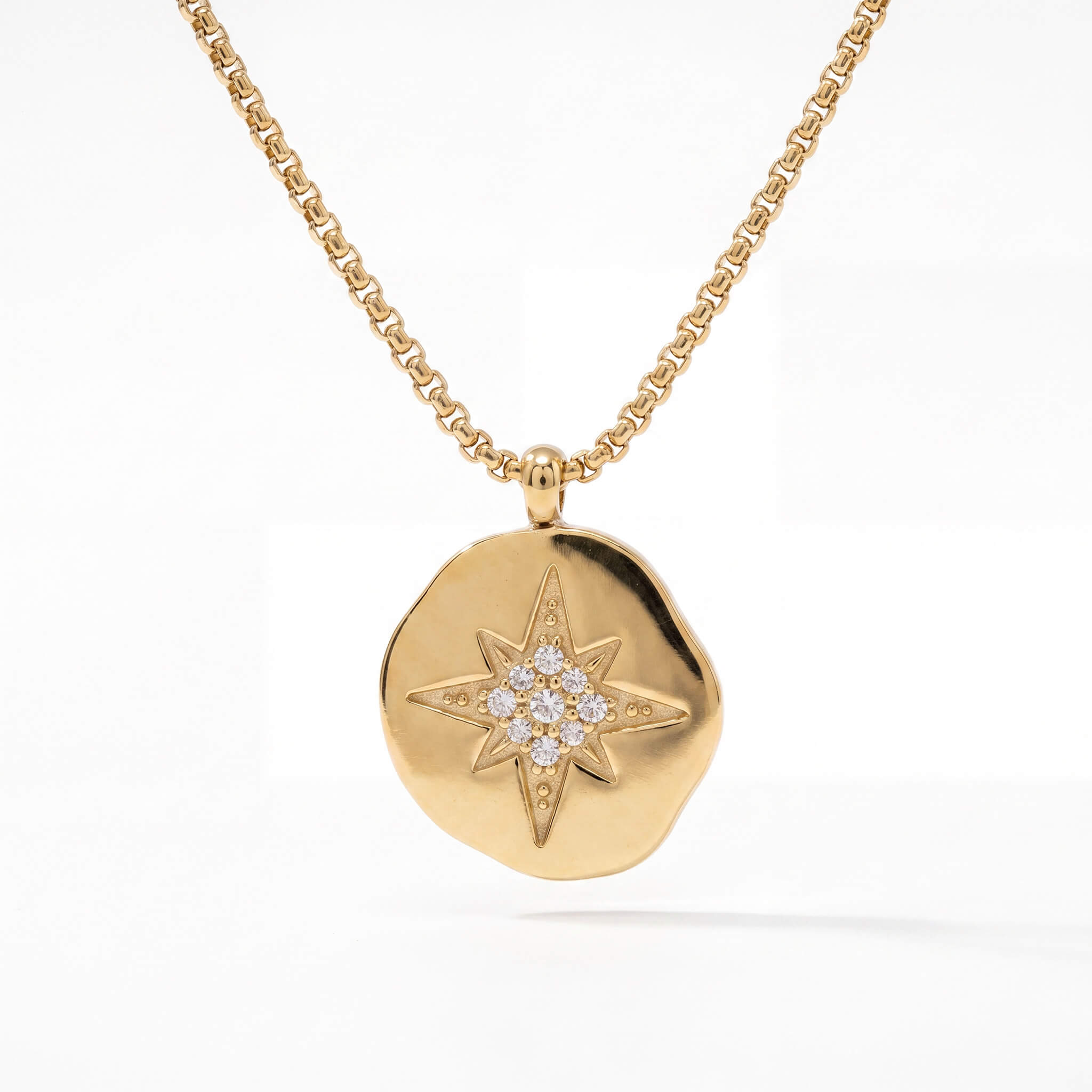 True North Necklace in gold, angled view of the star pendant on a box chain