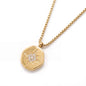 True North Necklace in gold with a textured coin pendant and star detail