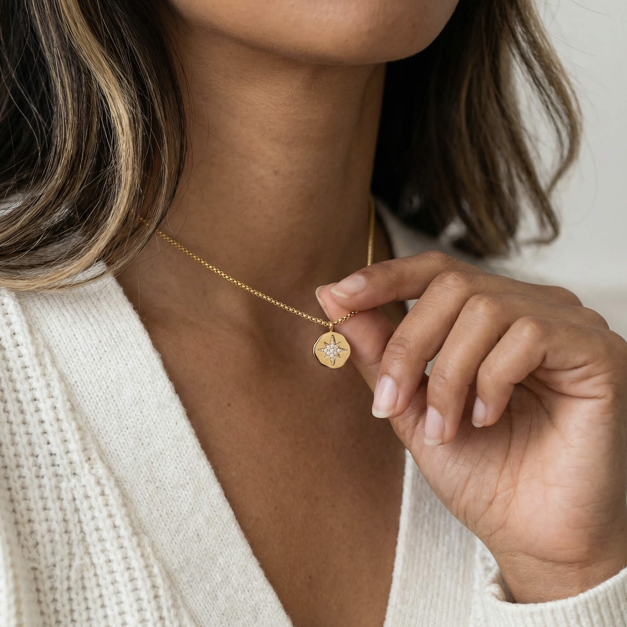 True North Necklace in gold worn on a woman's neck in a lifestyle photo