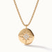 True North Necklace – close-up of the star-compass medallion with clear stones, gold, on ivory background