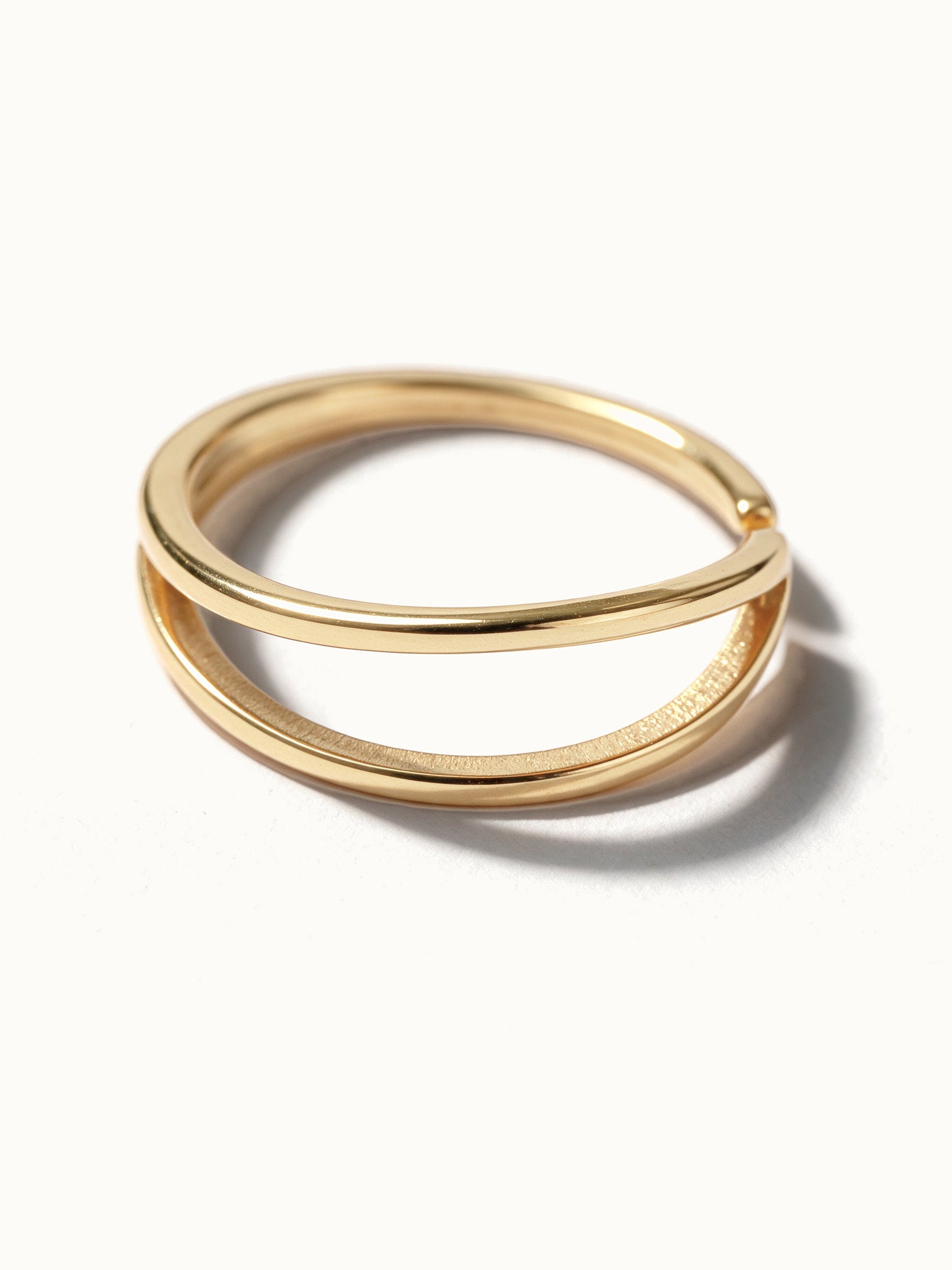 Two Paths Ring – close-up of the two parallel bands, gold, on ivory background