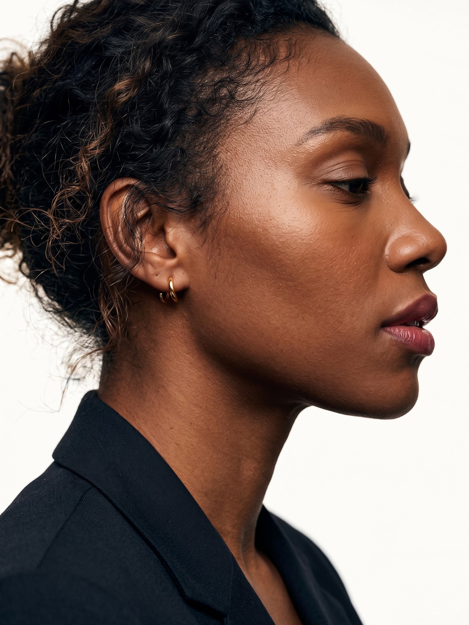 Whisper Hoops – worn in the ear, side profile, gold, curly hair up