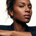 Whisper Hoops – worn in the ear, direct gaze with head tilted, gold, curly hair up