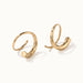 Whisper Hoops – pair of curved hoops, close-up, gold, on ivory background