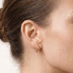 Whisper Hoops – worn in the ear, side profile, gold, hair in a low bun