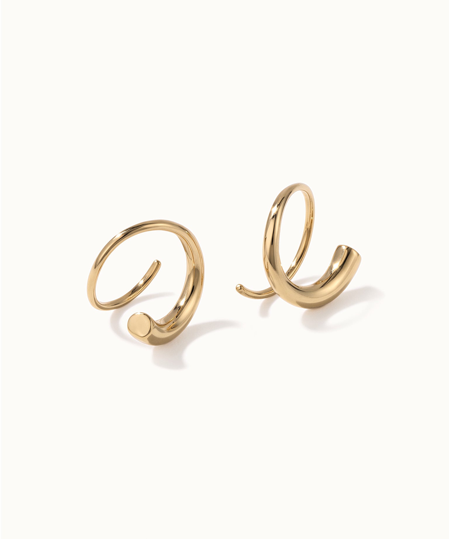 Whisper Hoops – pair of curved hoops, gold, on ivory background